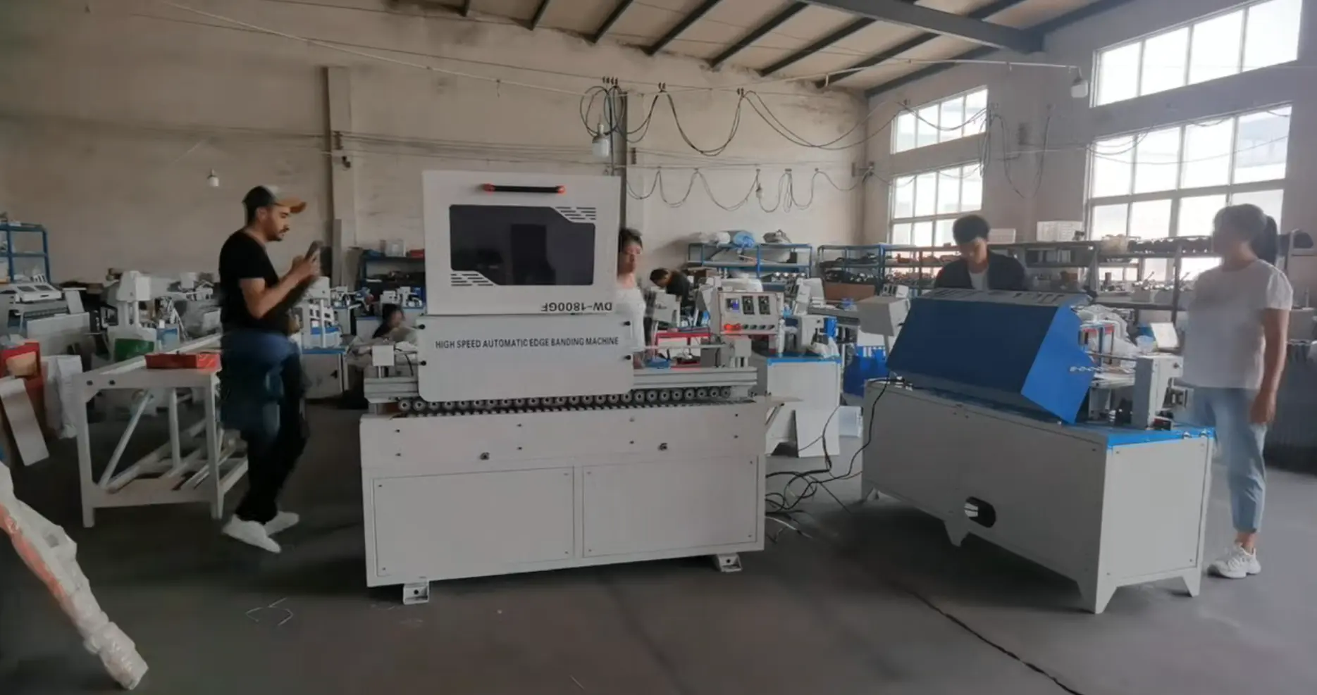 Overseas client inspecting woodworking machine at Ruiqi factory